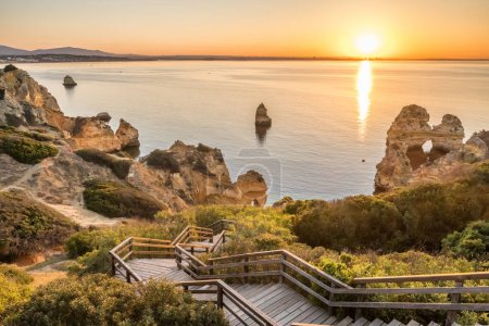 Photo for Praia do Camilo beach at sunrise near Lagos town, Algarve province, Portugal. Beautiful Camilo beach in the morning. White sand beach with in rocky lagoon. - Royalty Free Image