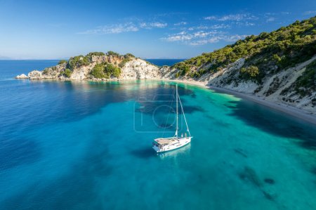 Photo for Aerial photo of a moored yacht boat near Gidaki beach with turquoise water in Itaca, Greece. Amazing sea water of the Ithaki island, Kefalonia, Ionian sea. - Royalty Free Image
