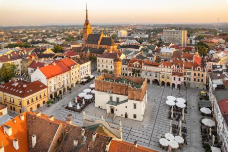 Aerial view of Tarnow old town at sunrise, Poland. Drone photo of the Tarnow cityscape with Cathedral Church of Holy Family, Rynek square with Town Hall and historic buildings at sunny morning.