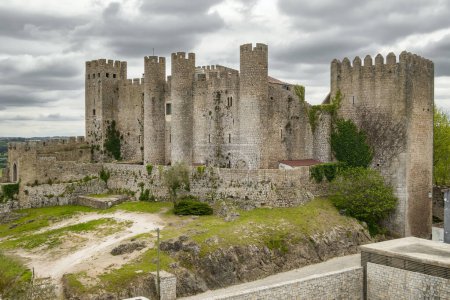 Photo for Castle of Obidos, a medieval fortified village at cloudy day in Portugal. Front view of medieval castle in Obidos - Royalty Free Image