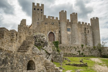 Photo for Castle of Obidos, a medieval fortified village at cloudy day in Portugal. Front view of medieval castle in Obidos - Royalty Free Image