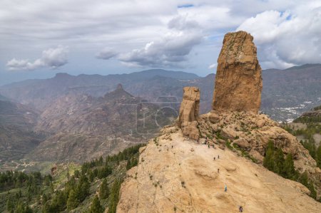Photo for Aerial view of the Roque Nublo, a volcanic rock in caldera of Tejeda, Gran Canaria, Canary islands, Spain. Roque Nublo rock formation landscape at cloudy day. Popular hiking destination. - Royalty Free Image