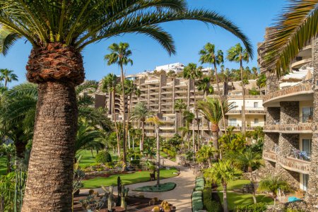 Photo for Large resort complex for family holidays on Gran Canaria island, Canary Islands, Spain. Palm trees, lush green plants and hotel building. Beautiful travel destination on Gran Canaria - Royalty Free Image