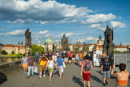 Photo for Prague, Czech Republic - June 12, 2022: Charles Bridge with historic statues, Lesser Town Bridge Tower and Judith tower at sunny day in Prague. People walk on famous Karlov most bridge - Royalty Free Image