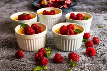 Photo for Custard with egg custard caramel flan dessert with raspberries - Royalty Free Image