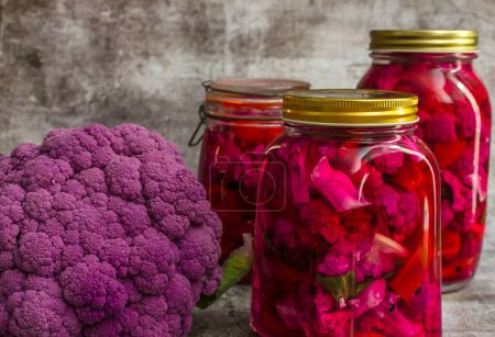 Photo for Homemade pickle with purple cauliflower in jars on a gray background - Royalty Free Image
