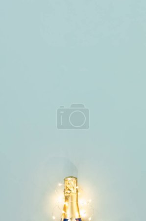 Photo for Golden decoration of ribbon, stars, Christmas balls and confetti flying from bottle of champagne. Flat lay. Festive concept copy space - Royalty Free Image