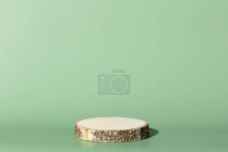 Photo for Round wooden saw cut cylinder shape on green background abstract background. Minimal box and geometric podium. Scene with geometrical forms. Empty showcase for eco cosmetic product presentation - Royalty Free Image