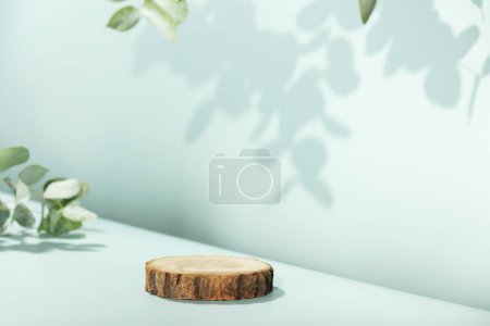 Téléchargez les photos : Résumé podium vide en tranches de bois avec des feuilles d'eucalyptus et des ombres sur fond bleu. Maquette stand pour la présentation des produits. 3D Render. Concept minimal. Modèle de publicité - en image libre de droit