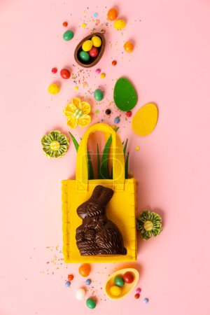 Photo for Felt Easter decorations and sweets on pink background, flat lay, top view - Royalty Free Image