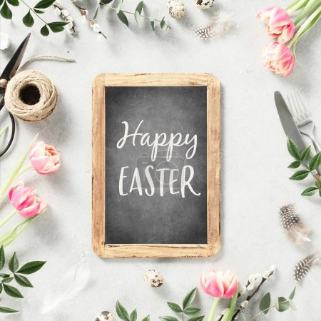 Photo for Easter table setting with vintage chalk board, spring flowers and cutlery on light grey background top view flat lay. Happy Easter holiday concept for cafes and restaurants. Copy space - Royalty Free Image