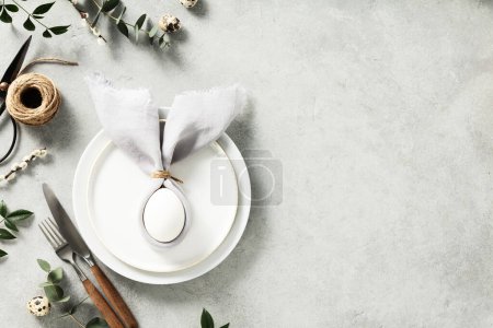 Photo for Banner. Stylish Easter flat lay, table setting with egg in easter bunny napkin. Modern natural dyed egg on napkin with bunny ears, flowers on vintage plate. Happy Easter holiday concept for cafes and - Royalty Free Image