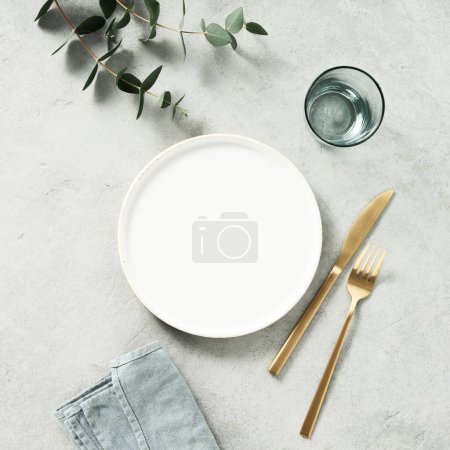 Photo for Minimal styled table setting with eucalyptus branches. Top view flat lay copy space. Square composition - Royalty Free Image