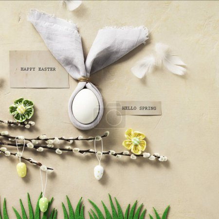 Foto de Easter Bunny Ears, eggs and spring willow branches top view flat lay. Minimal styled Easter card concept - Imagen libre de derechos