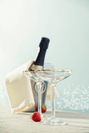 Photo for Bottle of champagne and glasses on sea and sky background. Summer holiday and romantic party concept - Royalty Free Image