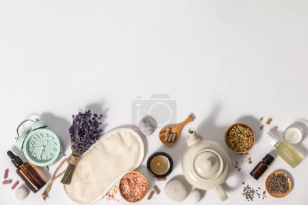 Photo for Herbal medicine for treat depression and insomnia concept. Alarm clock, sleep mask, medicine herbs, capsules, camomile tea and aromatherapy oil on white background, top view, copy space - Royalty Free Image