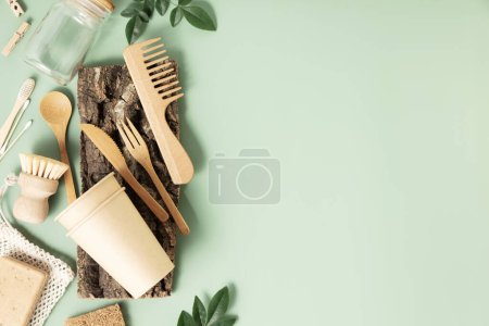 Photo for Set of reusable eco friendly products . Zero waste concept. Eco natural paper cups, bamboo cutlery, natural cleaning products on pastel green background, flat lay. Plastic free sustainable lifestyle - Royalty Free Image