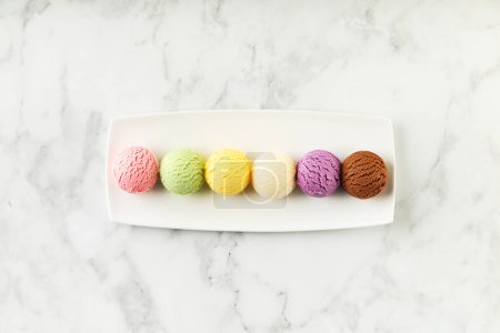 Photo for Set of various ice cream scoops on white marble background. Strawberry, pistachio, mango, vanilla, blueberry and chocolate ice cream. Top view, flat lay - Royalty Free Image