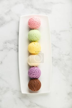 Photo for Set of various ice cream scoops on white marble background. Strawberry, pistachio, mango, vanilla, blueberry and chocolate ice cream. Top view, flat lay - Royalty Free Image