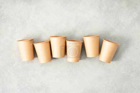 Photo for Flat lay composition with eco-friendly paper cups on grey stone background. Zero waste packaging concept - Royalty Free Image