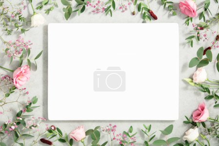 Photo for Frame made of eucalyptus branches, spring flowers and ceramic board on concrete background. Flat lay,copy space - Royalty Free Image