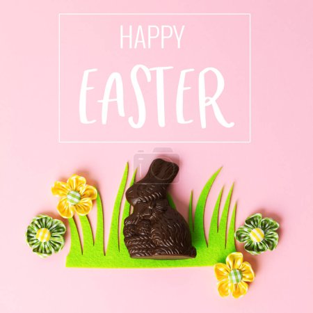 Photo for Felt Easter decorations and sweets on pink background, flat lay, top view. Happy Easter greeting card - Royalty Free Image
