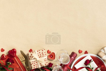 Photo for Valentines day composition with gift box in craft recycling paper, roses, candles, cutlery, champagne, chocolate, top view, flat lay, copy space - Royalty Free Image