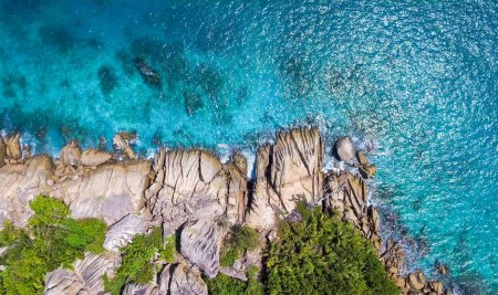 Overhead aerial view of beautiful Seychelles Beach and mountains in La Digue.