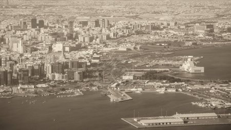 Photo for Doha, Qatar. Aerial view of city skyline from a flying airplane over the Qatar capital. - Royalty Free Image
