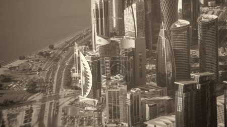 Photo for Doha, Qatar - December 12, 2016: Aerial view of city skyline from a flying airplane over the Qatar capital. - Royalty Free Image