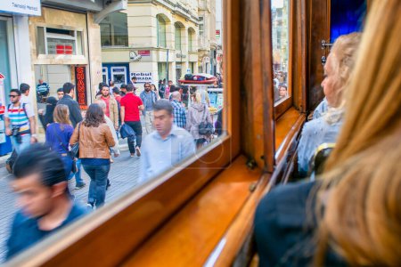 Photo for Istanbul, Turkey - October 2014: Tourists and locals walk along the crowded Istiklal Caddesi. - Royalty Free Image
