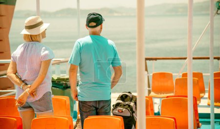Photo for Alonissos, Greece - July 6th, 2022: Elderly couple enjoy ferry trip between islands. - Royalty Free Image