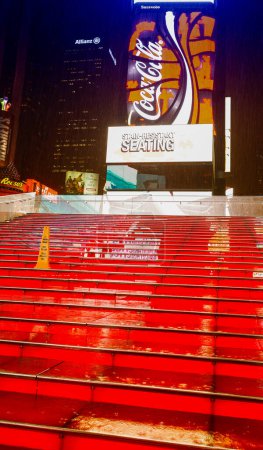 Photo for NEW YORK CITY - MAY 27: Wet red stairs of Duffy Square in Times Square May 27, 2013 in New York, NY. Times Square is the world's most visited tourist attraction bringing over 39 million tourists annually - Royalty Free Image