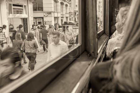 Photo for Istanbul, Turkey - October 2014: Tourists and locals walk along the crowded Istiklal Caddesi. - Royalty Free Image