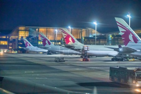 Photo for Doha, Qatar - August 17, 2018: Airplanes at night on the runway of Hamad International Airport. - Royalty Free Image