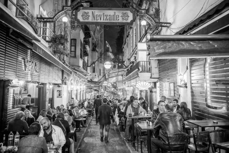Photo for Istanbul, Turkey - October 2014:Tourists and locals at night along the crowded city streets. - Royalty Free Image