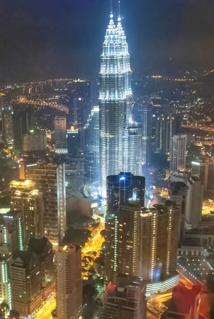 Photo for Kuala Lumpur, Malaysia - August 9, 2009: Petronas Twin Towers, aerial view at night. - Royalty Free Image