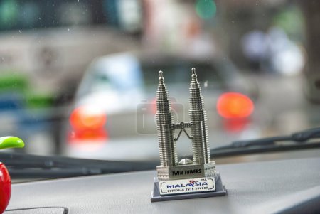 Photo for Kuala Lumpur, Malaysia - August 9, 2009: Petronas Twin Towers on a car dashboard. They are the city symbol. - Royalty Free Image