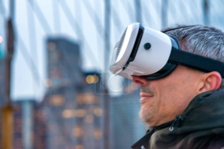 Photo for Happy man wearing a virtual reality visor exploring the city. - Royalty Free Image