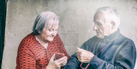 Photo for Elderly couple trying to figure out how to use a smarphone - Royalty Free Image