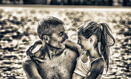 Photo for Father and daughter on holiday along the lake looking each other with love. Travel, holiday and vacation concept - Royalty Free Image