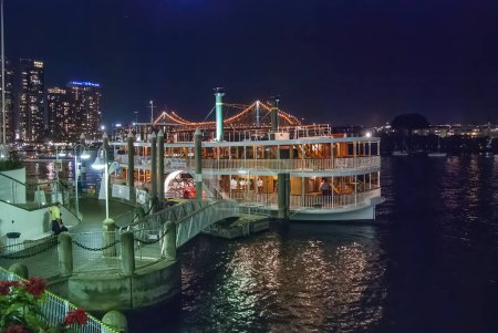 Photo for Brisbane, Australia - August 14, 2009: River tourist ferry and night city skyline. - Royalty Free Image