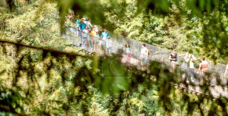 Photo for Vancouver, Canada - August 11, 2017: People at Capilano Bridge. It is a Suspension bridge crossing the Capilano River, 140 metres long and 70 metres above the river - Royalty Free Image