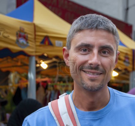 Foto de Happy man visiting a street market in Asia. - Imagen libre de derechos