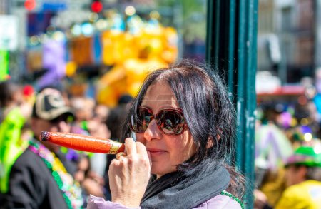 Photo for Happy woman at New Orleans carnival on Mardi gras major event pretends to smoke a toy cigar. - Royalty Free Image