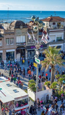 Photo for Viareggio, Italy - February 10, 2013: Crowd along the city promenade attending the Carnival Float Parade, aerial view from a high vantage point - Royalty Free Image