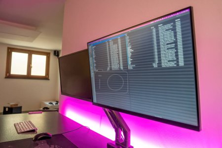 Double screen arm and led strips in a modern office studio.