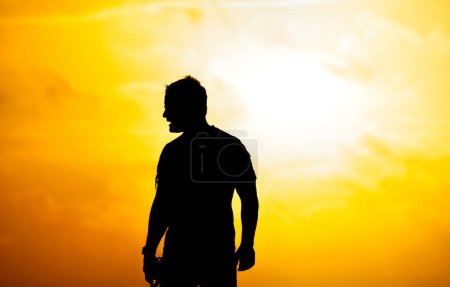 Foto de Silueta de un hombre mirando al mar en la playa. - Imagen libre de derechos