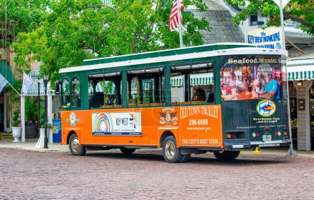 Photo for Key West, FL - February 21, 2016: City orange trolley is a famous tourist attraction. - Royalty Free Image