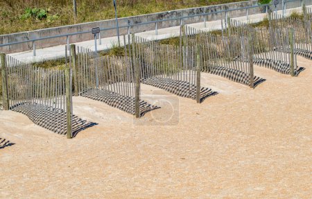 Foto de Beach space separators made of wood. Dividers with wooden slats. - Imagen libre de derechos